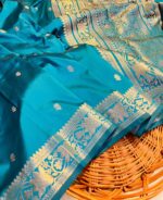 "Teal blue Banarasi soft silk saree with golden zari booti work and elegant woven pallu – lightweight, luxurious saree ideal for weddings and festive occasions."