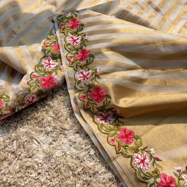 Woman wearing beige Banarasi tissue silk saree with elegant floral embroidery work for festive and wedding occasions