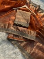 Woman wearing sunset orange Banarasi tissue silk saree with elegant stone work for wedding and festive occasions