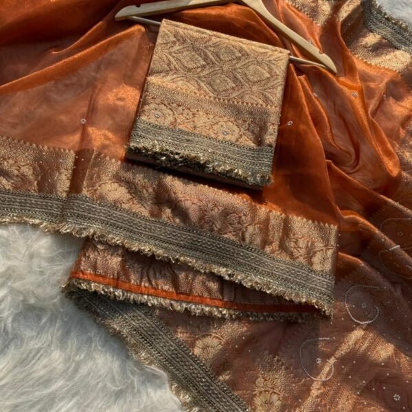 Woman wearing sunset orange Banarasi tissue silk saree with elegant stone work for wedding and festive occasions
